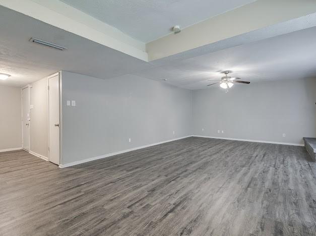 1901 Castille Dr, Carrollton, TX 75007 - unfurnished room with dark wood-style flooring, baseboards, and a ceiling fan