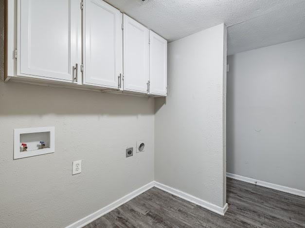 1901 Castille Dr, Carrollton, TX 75007 - washroom featuring cabinet space, electric dryer hookup, dark wood-style flooring, washer hookup, and baseboards