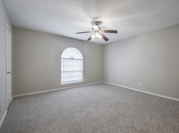 1901 Castille Dr, Carrollton, TX 75007 - empty room featuring ceiling fan, carpet flooring, and baseboards