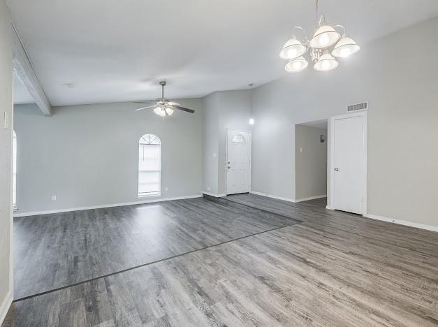 1901 Castille Dr, Carrollton, TX 75007 - unfurnished living room with a ceiling fan, wood finished floors, a chandelier, and baseboards