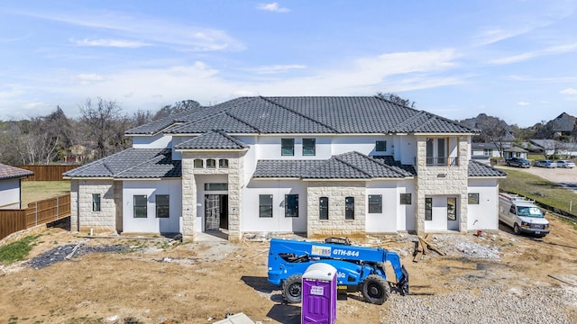 1010 W Mcdonwell School Rd, Colleyville, TX 76034 - rear view of property with a tiled roof, stone siding, and stucco siding