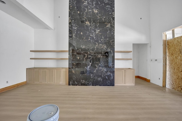 1010 W Mcdonwell School Rd, Colleyville, TX 76034 - unfurnished living room with wood finished floors, a towering ceiling, and baseboards