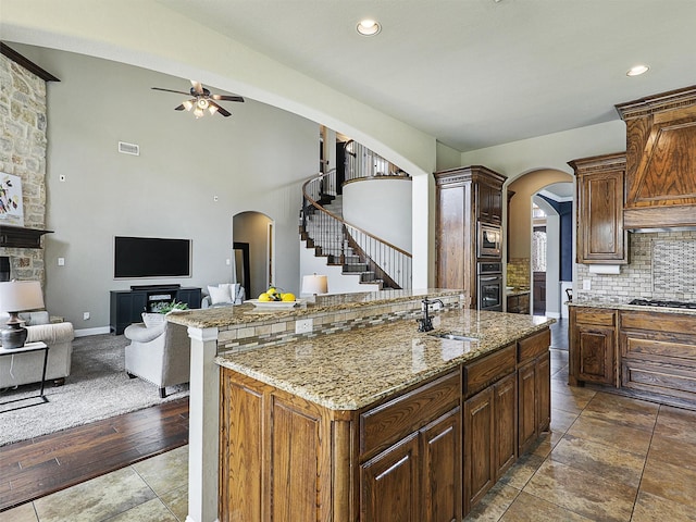2420 Lilyfield Dr, Trophy Club, TX 76262 - kitchen featuring arched walkways, a sink, stainless steel appliances, a ceiling fan, and recessed lighting