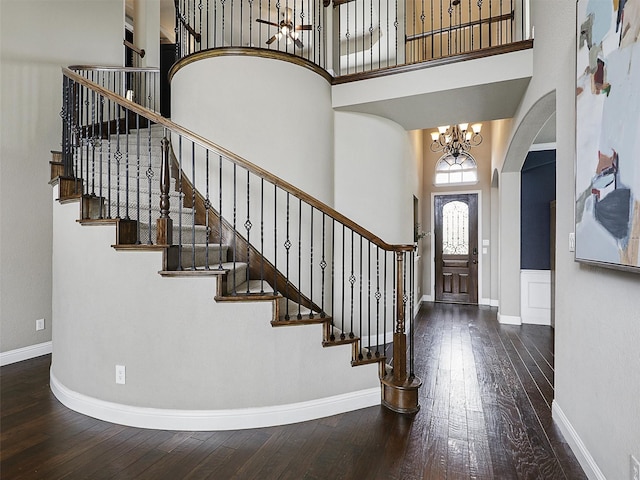 2420 Lilyfield Dr, Trophy Club, TX 76262 - foyer featuring arched walkways, a high ceiling, hardwood / wood-style flooring, a chandelier, and stairs