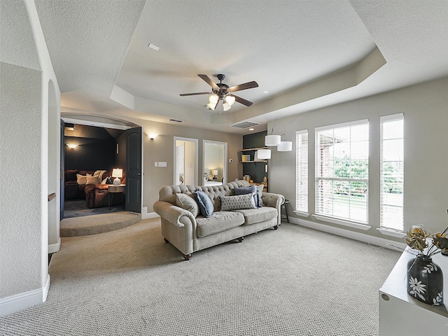 2420 Lilyfield Dr, Trophy Club, TX 76262 - living area featuring a raised ceiling, light colored carpet, a ceiling fan, baseboards, and a textured ceiling