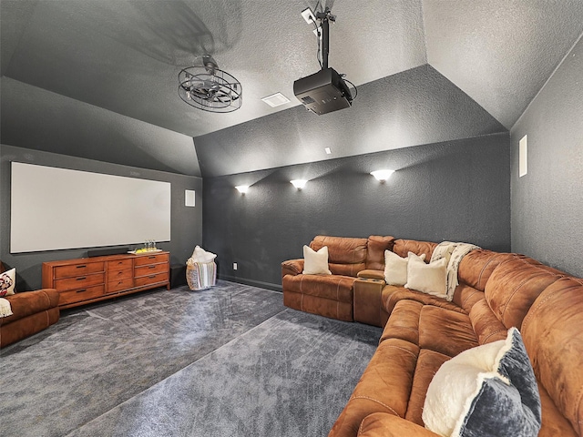 2420 Lilyfield Dr, Trophy Club, TX 76262 - carpeted home theater room featuring a textured wall, lofted ceiling, a textured ceiling, and baseboards