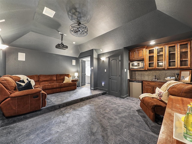 2420 Lilyfield Dr, Trophy Club, TX 76262 - carpeted living room featuring lofted ceiling, a textured ceiling, and a sink