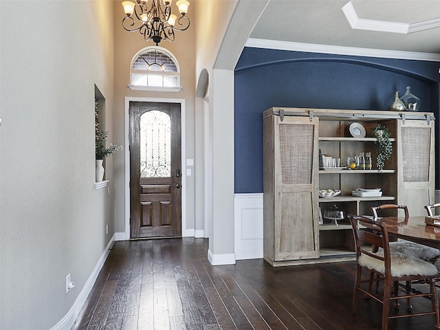 2420 Lilyfield Dr, Trophy Club, TX 76262 - entrance foyer featuring arched walkways, wood-type flooring, a chandelier, crown molding, and baseboards