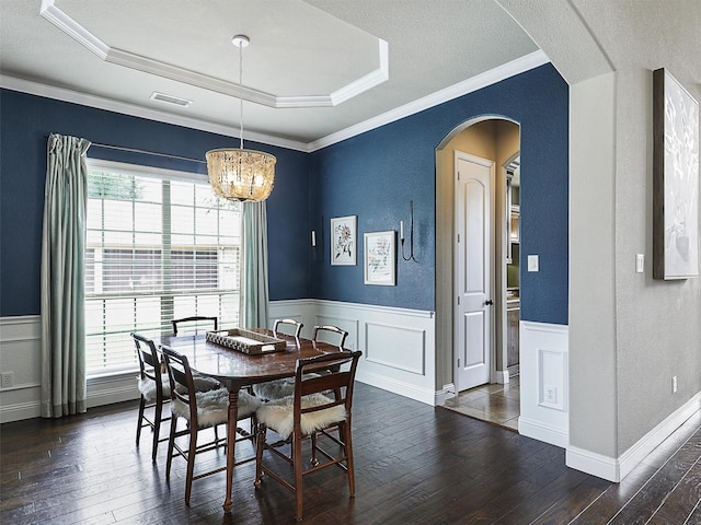 2420 Lilyfield Dr, Trophy Club, TX 76262 - dining area featuring healthy amount of natural light, dark wood-style flooring, a wainscoted wall, a chandelier, and arched walkways