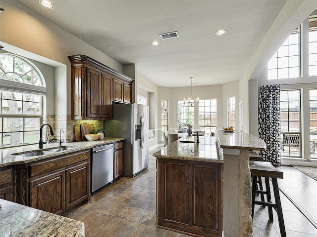 2420 Lilyfield Dr, Trophy Club, TX 76262 - kitchen featuring appliances with stainless steel finishes, a sink, healthy amount of natural light, a chandelier, and recessed lighting
