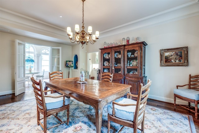 4107 Turtle Creek Blvd, Dallas, TX 75219 - dining space featuring a chandelier, wood finished floors, baseboards, and ornamental molding