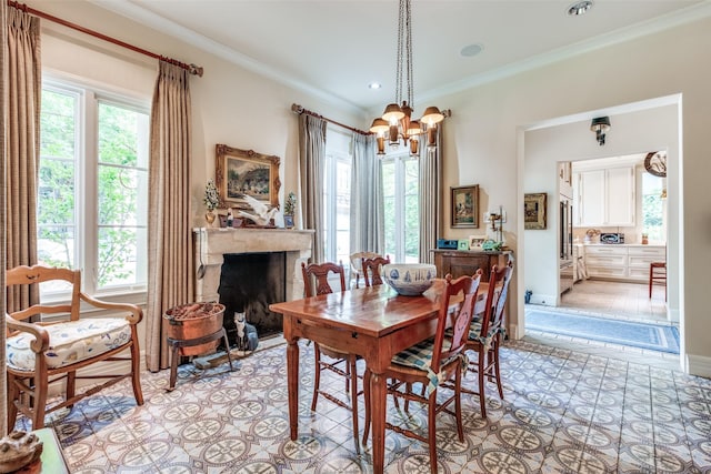 4107 Turtle Creek Blvd, Dallas, TX 75219 - dining room featuring healthy amount of natural light, a chandelier, crown molding, a fireplace, and recessed lighting