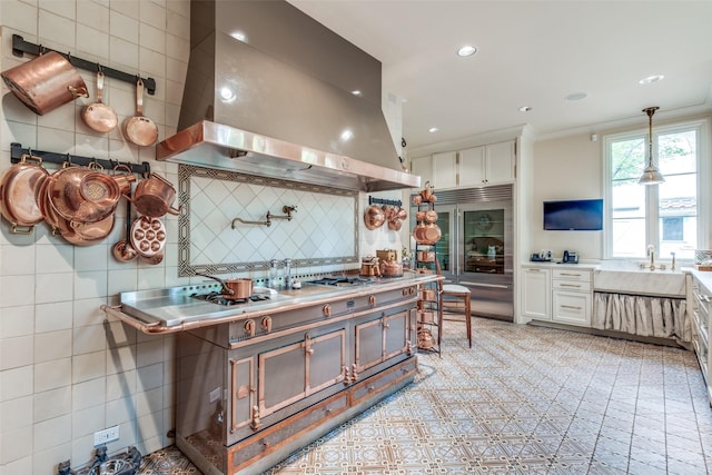 4107 Turtle Creek Blvd, Dallas, TX 75219 - kitchen featuring island range hood, built in refrigerator, a sink, light countertops, and recessed lighting