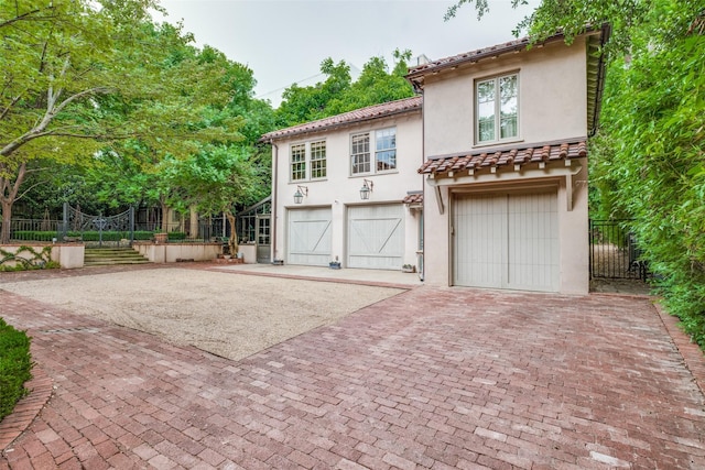 4107 Turtle Creek Blvd, Dallas, TX 75219 - mediterranean / spanish home featuring decorative driveway, stucco siding, a garage, and a tiled roof