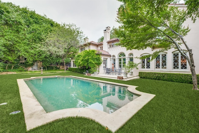 4107 Turtle Creek Blvd, Dallas, TX 75219 - back of house with a patio, a yard, an outdoor pool, and a chimney