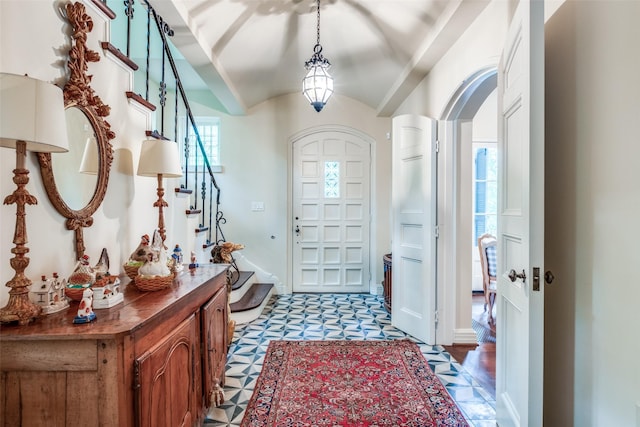 4107 Turtle Creek Blvd, Dallas, TX 75219 - foyer entrance with light floors, stairway, lofted ceiling, and arched walkways
