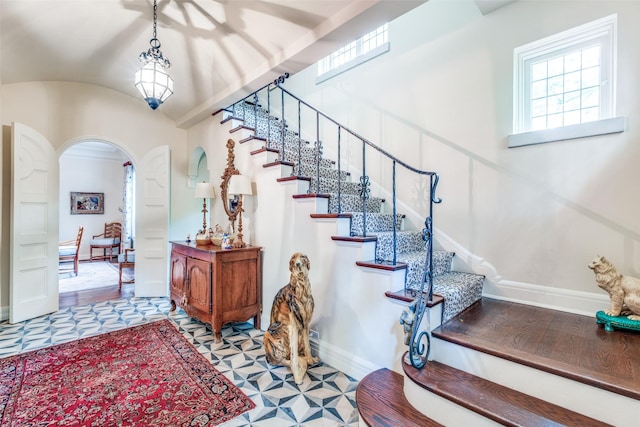 4107 Turtle Creek Blvd, Dallas, TX 75219 - stairway featuring arched walkways, baseboards, and vaulted ceiling