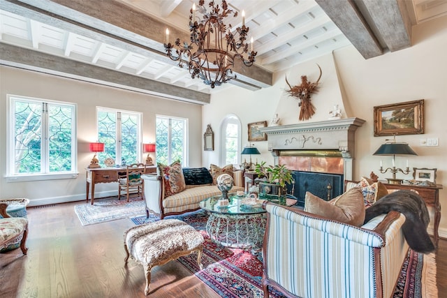 4107 Turtle Creek Blvd, Dallas, TX 75219 - living room with beam ceiling, wood finished floors, a chandelier, baseboards, and a large fireplace