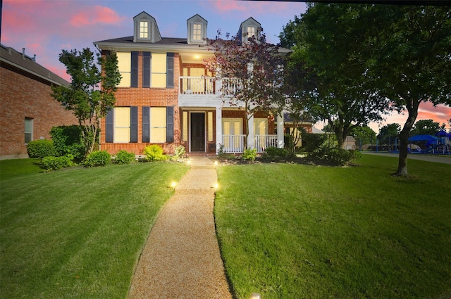 10014 Fairway Vista Dr, Rowlett, TX 75089 - colonial house featuring a balcony, french doors, brick siding, and a front lawn