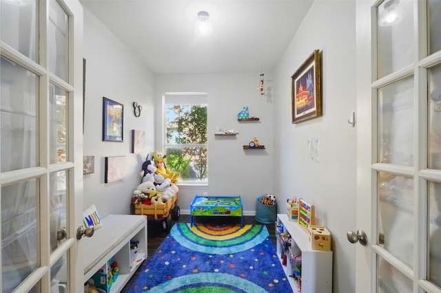 10014 Fairway Vista Dr, Rowlett, TX 75089 - playroom featuring french doors, baseboards, and wood finished floors