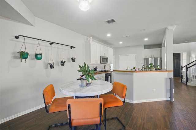 10014 Fairway Vista Dr, Rowlett, TX 75089 - dining room with dark wood-type flooring, recessed lighting, baseboards, and stairs