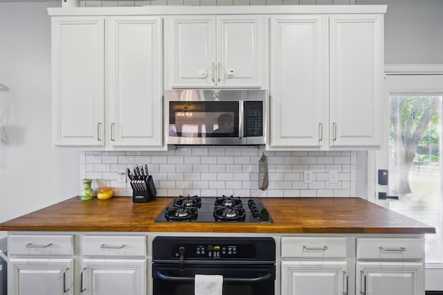 10014 Fairway Vista Dr, Rowlett, TX 75089 - kitchen with black appliances, wood counters, decorative backsplash, and white cabinetry