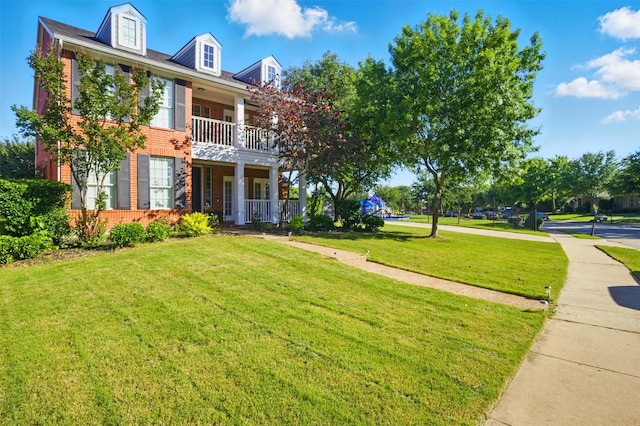 10014 Fairway Vista Dr, Rowlett, TX 75089 - view of front of house featuring brick siding, a front yard, a balcony, and covered porch