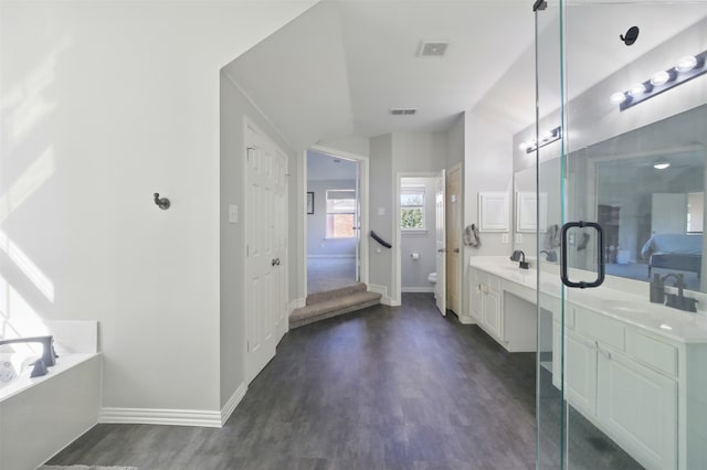 10014 Fairway Vista Dr, Rowlett, TX 75089 - full bath with vanity, toilet, baseboards, wood finished floors, and vaulted ceiling