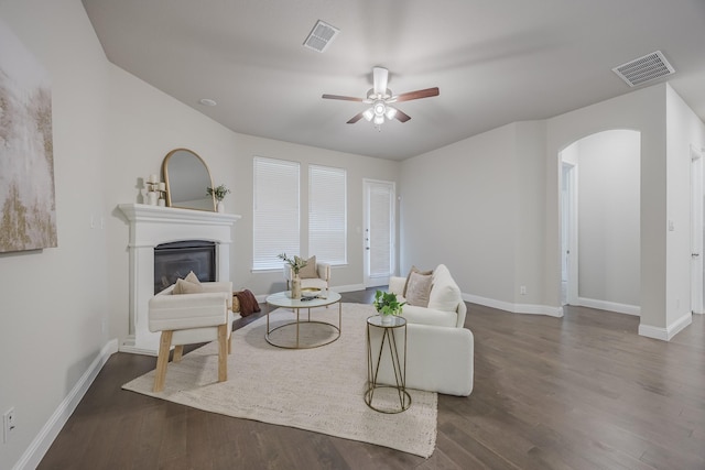 14844 Gentry Dr, Aledo, TX 76008 - living area with arched walkways, baseboards, dark wood-style flooring, and a ceiling fan