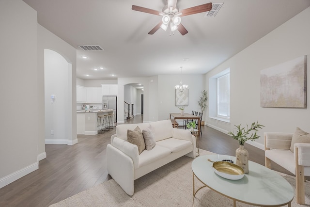 14844 Gentry Dr, Aledo, TX 76008 - living area with arched walkways, light wood-style floors, a ceiling fan, baseboards, and a chandelier
