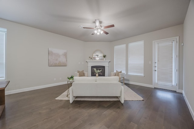 14844 Gentry Dr, Aledo, TX 76008 - living room featuring dark wood-type flooring, a ceiling fan, a glass covered fireplace, and baseboards