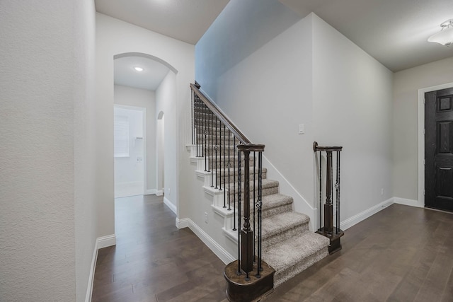 14844 Gentry Dr, Aledo, TX 76008 - entrance foyer featuring arched walkways, dark wood-type flooring, stairway, and baseboards