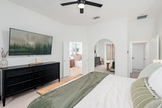 3159 Market Center Dr, Rockwall, TX 75032 - bedroom with light colored carpet, ensuite bath, ceiling fan, and arched walkways