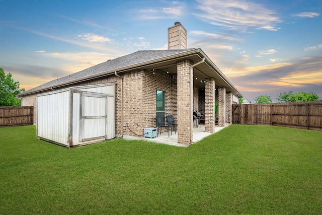 3159 Market Center Dr, Rockwall, TX 75032 - rear view of house featuring a patio area, brick siding, a chimney, and roof with shingles