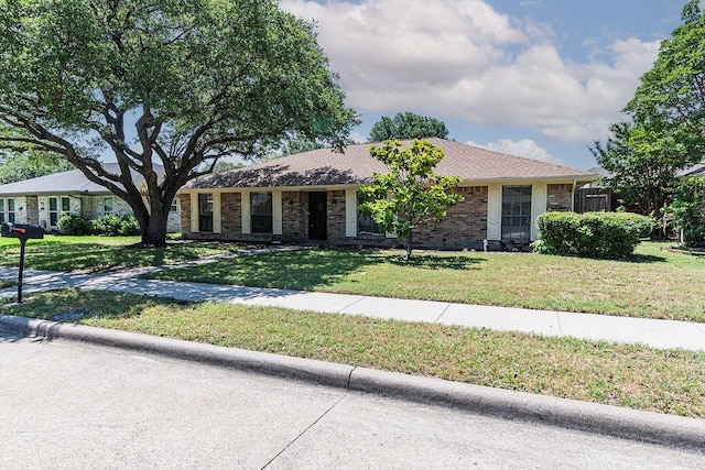 1720 Hearthstone Dr, Plano, TX 75023 - ranch-style house featuring a front lawn and brick siding