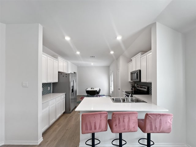1192 Norias Dr, Forney, TX 75126 - kitchen featuring stainless steel appliances, a breakfast bar area, tasteful backsplash, and recessed lighting