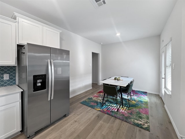 1192 Norias Dr, Forney, TX 75126 - kitchen featuring stainless steel fridge with ice dispenser, light wood finished floors, and white cabinets
