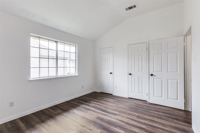 3713 Dentelle Dr, Plano, TX 75023 - unfurnished bedroom with multiple closets, lofted ceiling, dark wood finished floors, and baseboards