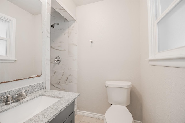 6917 Richlynn Ter, Richland Hills, TX 76118 - bathroom featuring vanity, a tile shower, toilet, tile patterned flooring, and baseboards