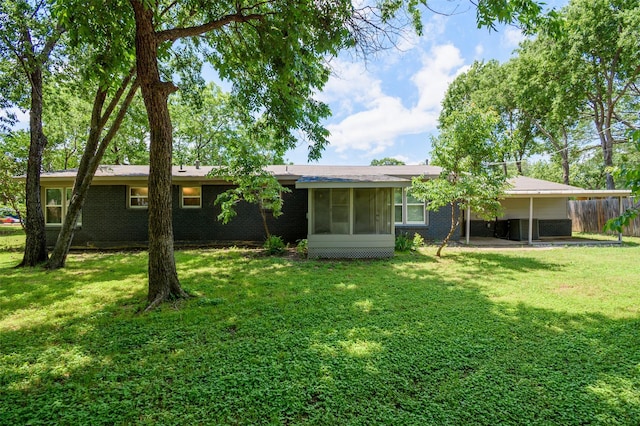 6917 Richlynn Ter, Richland Hills, TX 76118 - rear view of property with a sunroom, a carport, and brick siding