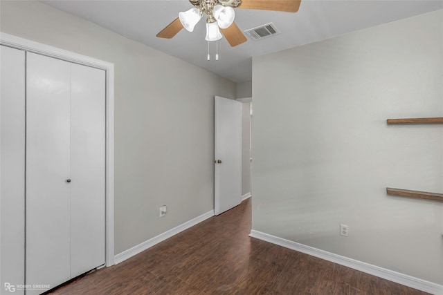 7008 Soda Point Dr, Shreveport, LA 71107 - unfurnished bedroom with baseboards, a closet, wood finished floors, and a ceiling fan