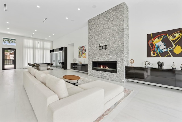 11110 Saint Michaels Dr, Dallas, TX 75230 - living area with a high ceiling, recessed lighting, a stone fireplace, and tile patterned flooring