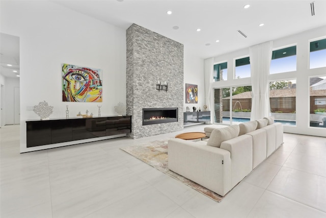 11110 Saint Michaels Dr, Dallas, TX 75230 - tiled living area with a towering ceiling, a stone fireplace, and recessed lighting