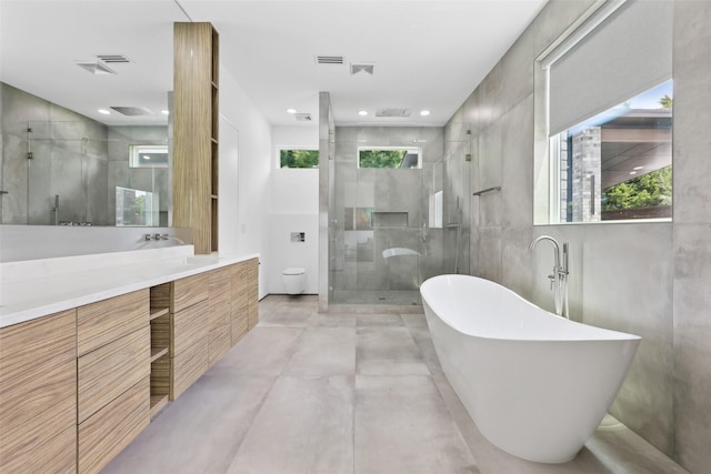 11110 Saint Michaels Dr, Dallas, TX 75230 - full bath with a stall shower, a freestanding bath, vanity, and concrete floors