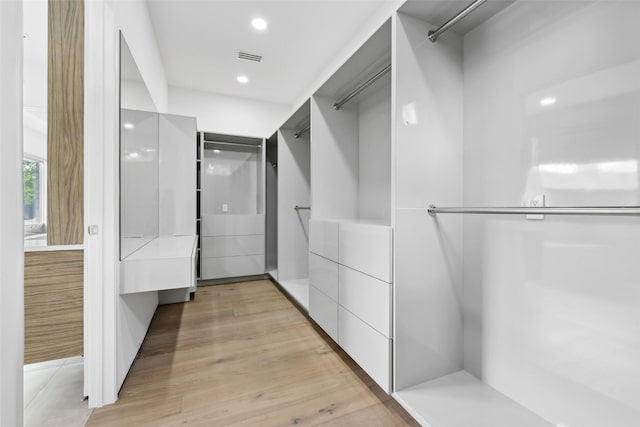11110 Saint Michaels Dr, Dallas, TX 75230 - walk in closet featuring light wood-style floors