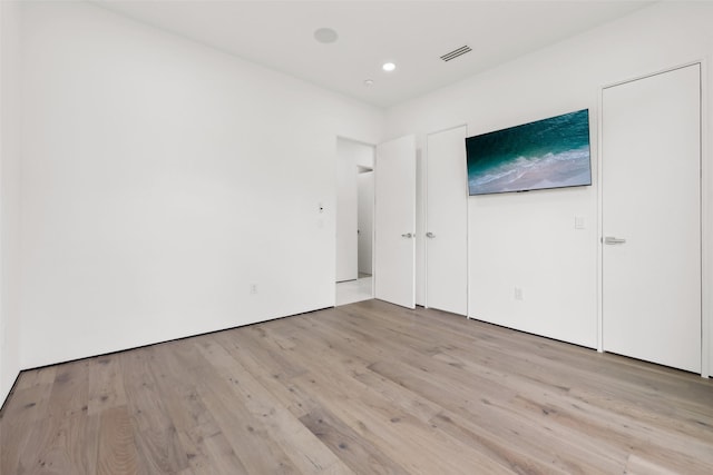 11110 Saint Michaels Dr, Dallas, TX 75230 - unfurnished bedroom featuring light wood-type flooring and recessed lighting