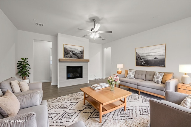 1021 Allegheny Ct, Burleson, TX 76028 - living area featuring wood finished floors, ceiling fan, a glass covered fireplace, and baseboards