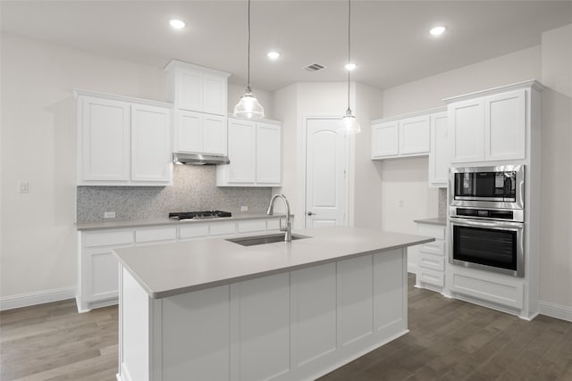 1021 Allegheny Ct, Burleson, TX 76028 - kitchen featuring stainless steel appliances, under cabinet range hood, a sink, dark wood-style floors, and recessed lighting