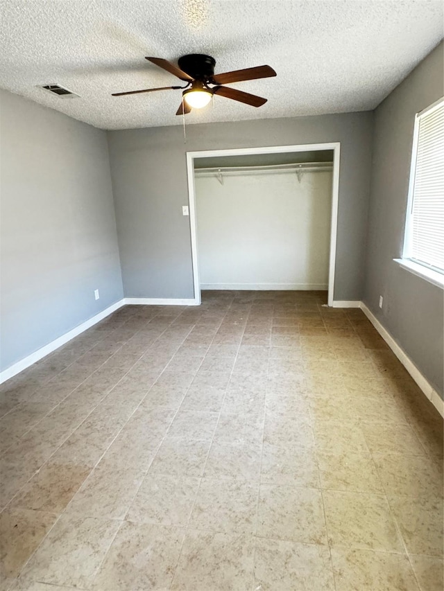 5412 Brookhollow Dr, Sachse, TX 75048 - unfurnished bedroom featuring a textured ceiling, a closet, ceiling fan, and baseboards