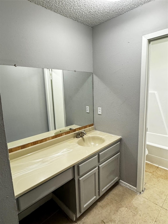5412 Brookhollow Dr, Sachse, TX 75048 - bathroom featuring vanity, tile patterned flooring, and a textured ceiling